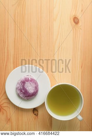 Top View Of Japanese Purple Sweet Potato Daifuku Or Red Bean Paste Filling Rice Cake With Green Tea 