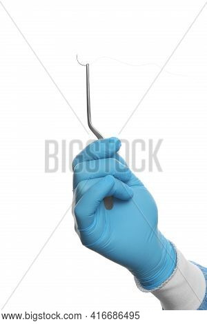 Doctor Holding Needle With Suture Thread On White Background, Closeup. Medical Equipment