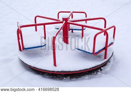 Childrens Merry-go-round Covered With Snow In Winter