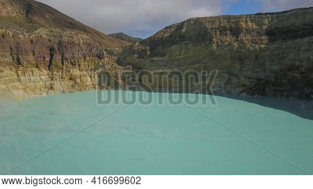 White Mist Hovers Over The Turquoise Surface Of The Volcanic Lake Kootainuamuri. Kelimutu Tri Colour