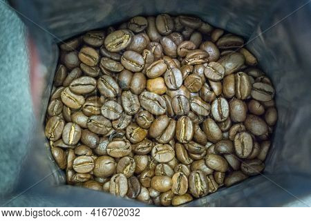 Coffee Beans In Open Packaging Coarsely. Quality Photo
