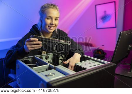 Smiling E-sport Gamer Girl Installing New Gpu Video Card In Her Gaming Pc