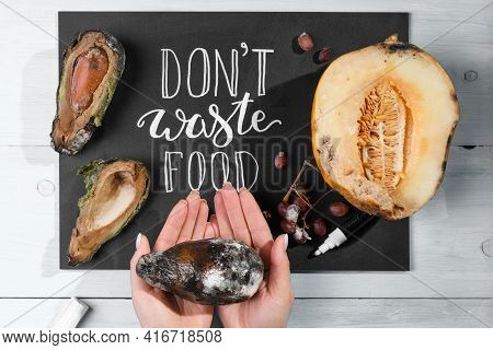 Close Up Of A Chalkboard With Don't Waste Food Lettering And Rotten Fruits. Selective Focus. Concept