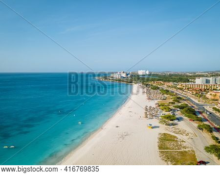 Eagle Beach Aruba, Palm Trees On The Shoreline Of Eagle Beach In Aruba, Drone View At A Beach With P