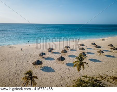 Eagle Beach Aruba, Palm Trees On The Shoreline Of Eagle Beach In Aruba, Drone View At A Beach With P
