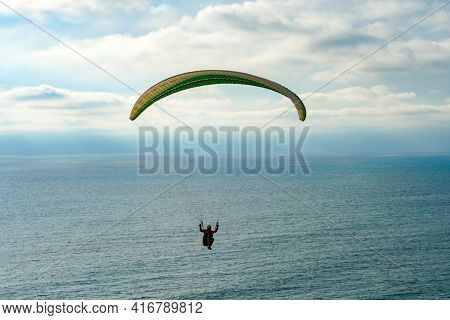 Man Doing Sport, Para-glider In The Clouded Sky. Paragliding Is An Extreme Sport And Recreation. Tor