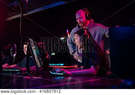 A Pretty Asian Woman And A Guy Spend A Date In A Computer Club, Play Computer Games Under The Superv
