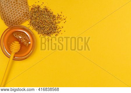 A Ladle Of Honey On The Background Of A Honeycomb Of A Bee. Honey Tidbit In A Glass Jar Honey Spoon,