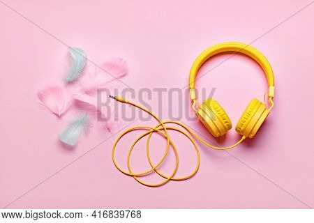 Yellow Headphones And Soft Feathers On Pink Background. Asmr Stress-relieving Sounds Concept, Flat L