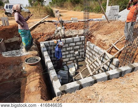 Closeup Of Indian Workers Construction Of New Building, Water Sump And Mixing Construction Material