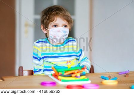 Preschool Boy With Medical Mask Having Fun With Dough, Colorful Modeling Clay. Creative Leisure With