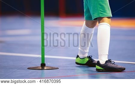 Indoor Football Player And Training Pole. Futsal Training For Children. Legs Of Young Futsal Player 