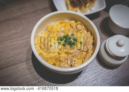 Japanes Food Gyudon Or Butadon With Egg Lunch Meal On Wood Table