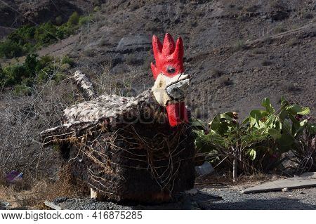 Giant Rooster In The Garden Of Villa Mogan, The Historic Windmill Molino De Viento, Mogan, Gran Cana