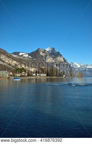 Splashing Water Fountain And An Alpine Scenery At The Walensee In Weesen In Switzerland 21.2.2021