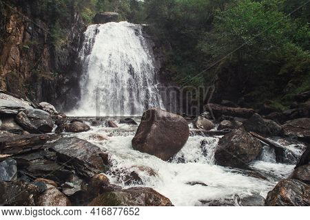 Korbu Waterfall at Lake Teletskoye in the Altai Mountains. The most famous lake waterfall