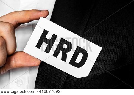 Hrd Human Resource Development Man In A Black Business Suit Lowers Or Removes From His Breast Pocket