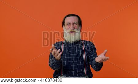 Happy Joyful Senior Old Bearded Gray-haired Man Laughing Out Loud After Hearing Ridiculous Anecdote,