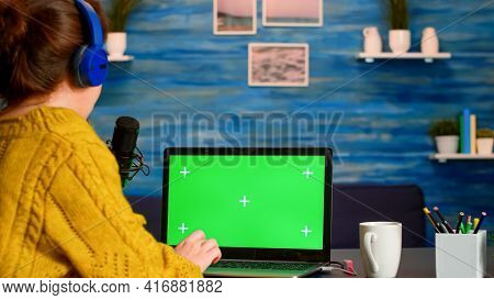 Vlogger Reading At Laptop With Chroma Key Desktop