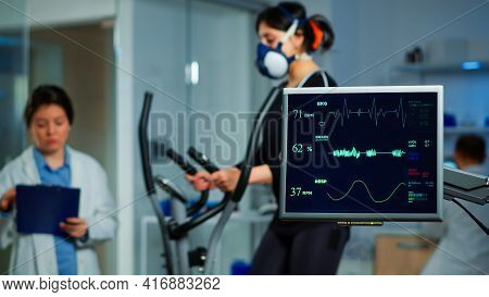 Monitor Showing Ekg Scan Of Athlete Running On Cross Trainer