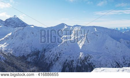 Beautiful Panoramic Shot Of Winter Mountain Peaks Covered In Snow During The Winter Season Against T