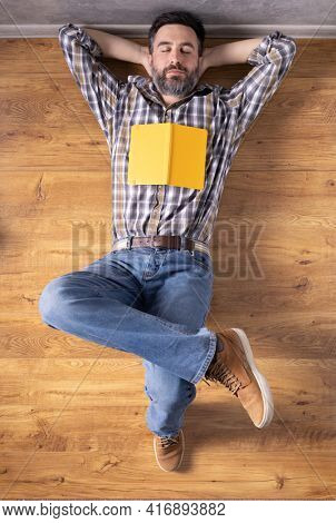 Man relaxing on floor thinking idea solitions. Man student lying studying and book or notebook. Creative inspiration study concept