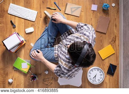 Man relaxing on floor thinking idea solitions. Man student studying online lesson listening music. Creative inspiration study concept