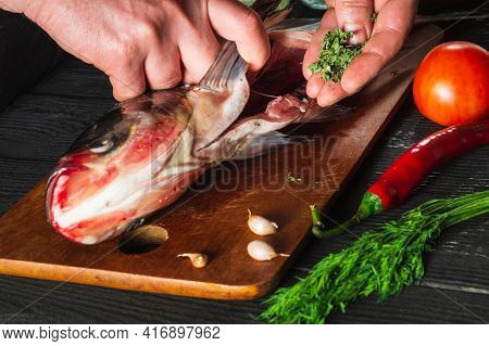 The Chef Prepares Fresh Fish Bighead Carp With Add Spice. Preparing To Cook Fish Food. Working Envir