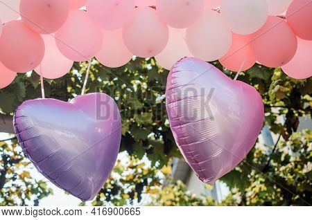Decor With Balloons For The Holiday. White And Pink Heart Shaped Balloons