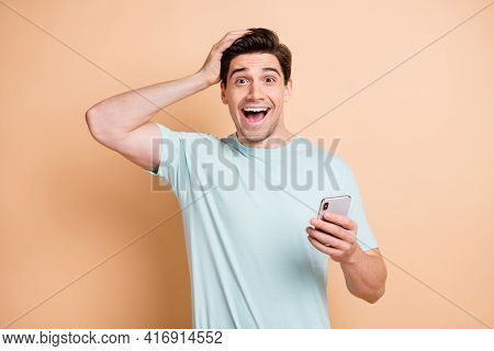 Portrait Of Nice Cheerful Amazed Guy Influenzer Using Device Browsing Media News Smm Isolated Over B
