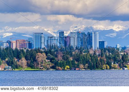 Modern Buildings In Bellevue, Washington With The Cascades Range In The Background.