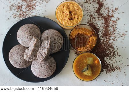 Steamed Cakes Made With Finger Millets And Skinned Black Gram. Locally Known As Ragi Idli. Served Al