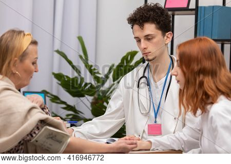 In A Physicians Office, A Nurse Practitioner Is Taking The Blood Pressure Of A Fifty-year-old Female