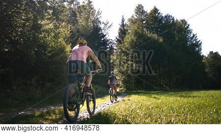 Two Girls On Mtb Bikes. Mother And Daughter Riding On A Forest Trail.