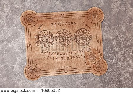 Talking Board Used On Seances For Communicating With The Dead. Shot From Overhead. Mediumship Divina