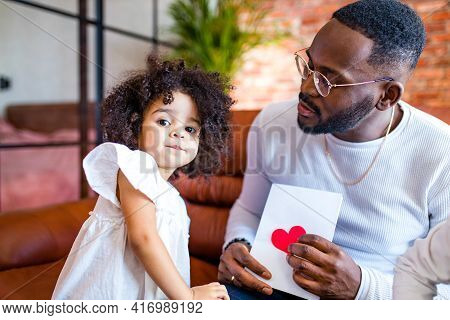 Afro American Baby Giving To Dad A Valentines Day Picture In Living Room