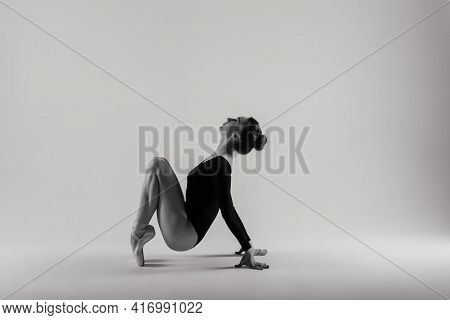 Portarit Of Sensual Professional Caucasian Callet Dancer In Body Suit And Pointes Shoes On White.