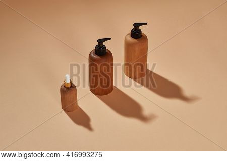 Wooden Bottles Of Different Sizes Isolated On Beige Background. Zero Waste And Eco Conscious Life. M