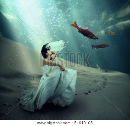 a pretty woman dancing underwater in the ocean