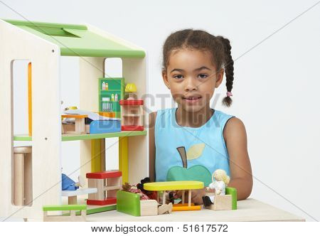 Pre-School Pupil Playing With Wooden House
