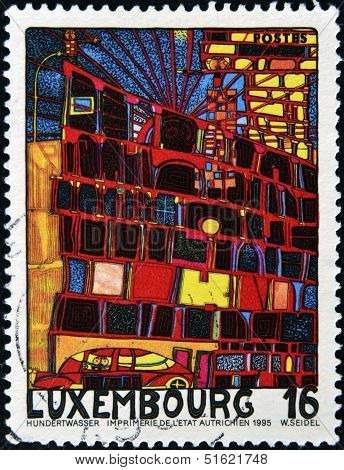 A stamp printed in Luxembourg shows the House with the Arcades and the Yellow Tower by Hundertwasser
