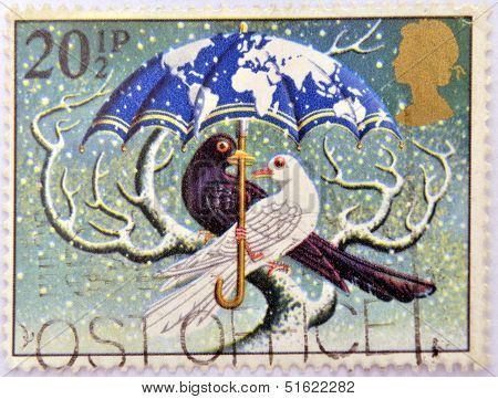 A christmas stamp printed in Grat Britain shows 'World at Peace' (Dove and Blackbird)