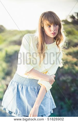 Reserved gorgeous blonde on the roadside posing on a glowing background