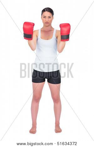Angry healthy model with boxing gloves posing on white background