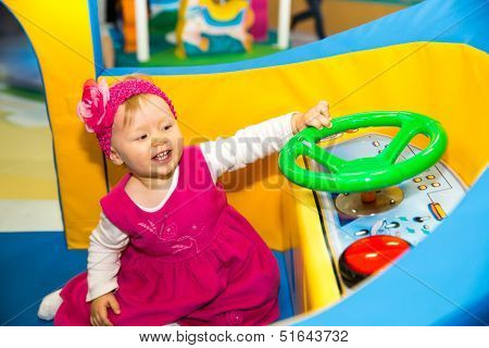 Happy Baby Girl  Keep On Board Ship On Playground. The Concept Of Childhood And Holiday