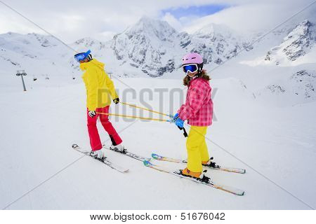 Skiing, skiers on ski run - child skiing downhill, ski lesson