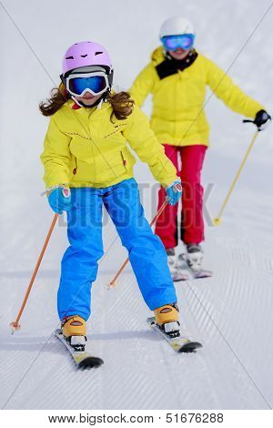 Skiing, skiers on ski run - child skiing downhill, ski lesson