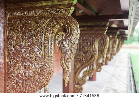 Golden wooden carving buttress in temple