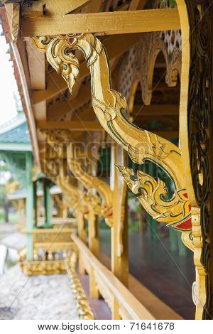 Golden wooden carving buttress in temple