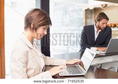 Business colleagues working on their break at the coffee shop